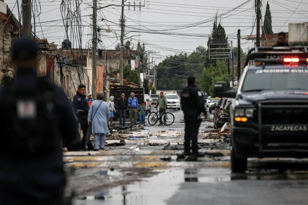 Residents look at the damage caused by a car bomb explosion in front of the municipal police station, in Ojocaliente, Zacatecas, Mexico, on Aug. 31, 2026. A car bomb exploded outside the police station the previous night, wounding six people, according to authorities. (Jess Mireles/AFP via Getty Images)