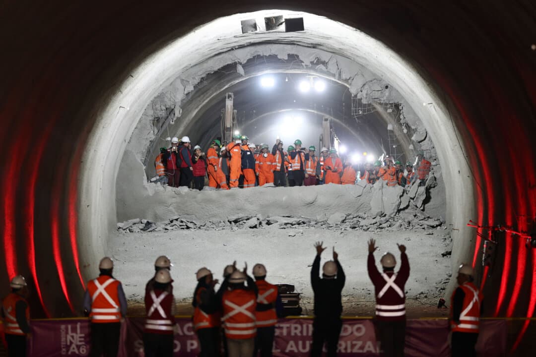 Workers celebrate the tunnel meeting at the construction site for the expansion of Santiago Metro Line 6, in Santiago, Chile, on Aug. 31, 2026. (Javier Torres/AFP via Getty Images)