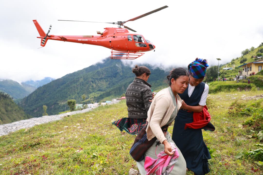 A Nepal Armed Police Force helicopter carrying relief supplies lands for flood-affected people in Rasuwa district, Nepal, on Sept. 1, 2026. A glacial collapse on the China-Nepal border triggered a surge of freezing water and debris that killed at least 939 people and left nearly 4,500 missing. (Prabin Ranabhat/AFP via Getty Images)
