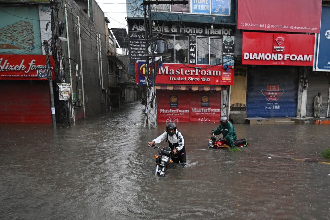 Commuters wade through a flooded street after heavy monsoon rainfall, in Rawalpindi, Pakistan, on Sept. 1, 2026. (Aamir Qureshi/AFP via Getty Images)