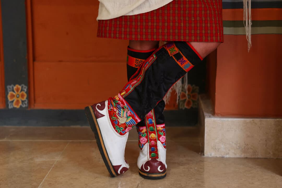A participant wears traditional Bhutanese tshoglham boots during the Global Conscious Food Systems Summit, in Paro, Bhutan, on Sept. 1, 2026. (Niharika Kulkarni/AFP via Getty Images)
