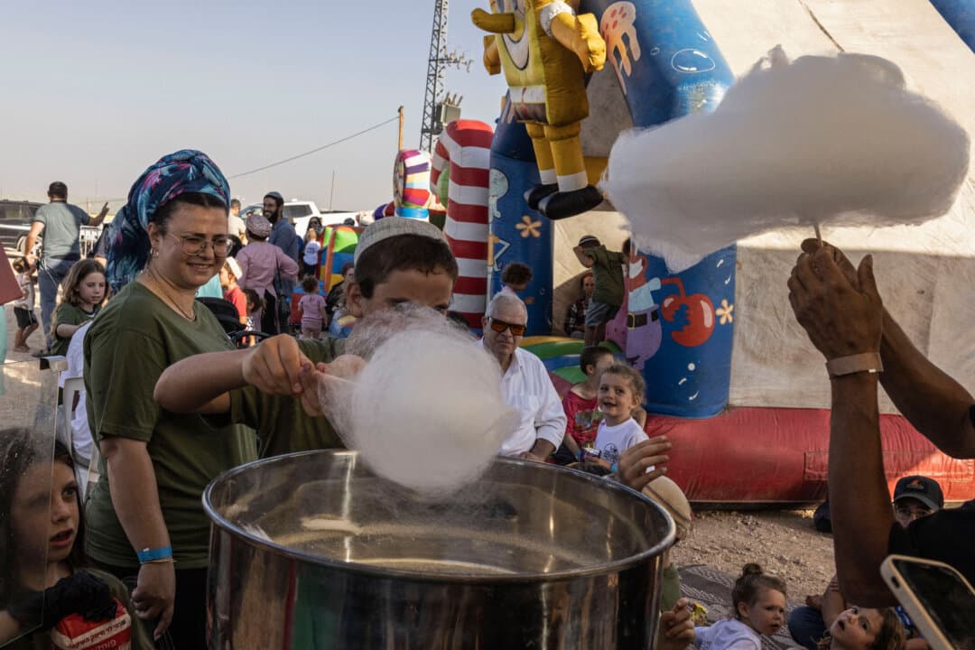 Families wait to buy cotton candy during the inauguration of the new Israeli settlement of Maale Arugot, in Gush Etzion, occupied West Bank, on Sept. 2, 2026. More than 500,000 Israelis live in West Bank settlements, alongside around 3 million Palestinians. (John Wessels/AFP via Getty Images)