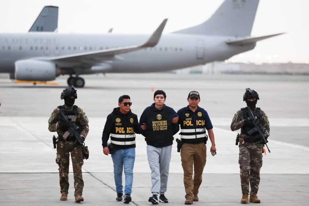 Jhonsson Smit Cruz Torres, leader of the criminal organization Los Pulpos and one of Peru’s most wanted men, arrives escorted by police officers at Group 8 of the Peruvian Air Force in El Callao, Lima, Peru, on Sept. 2, 2026, after being extradited from Bolivia. (Connie France/AFP via Getty Images)