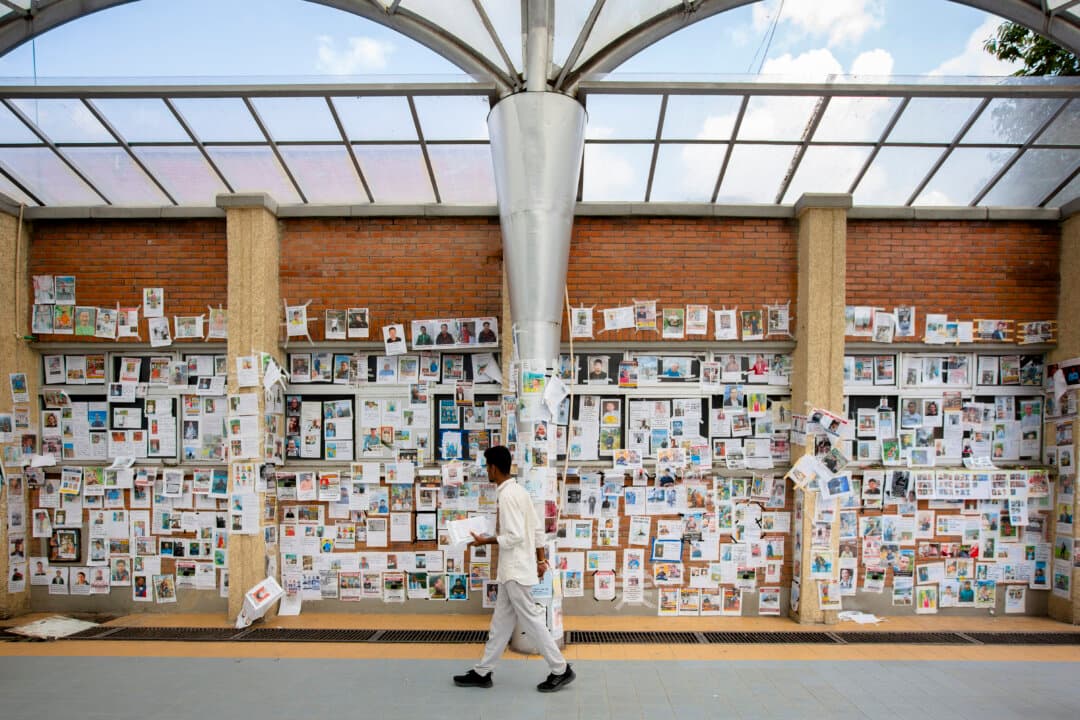 A man walks past a wall covered with photographs of people reported missing after the recent floods in the Himalayan valley along the Nepal–Tibet border, inside the Tribhuvan University Teaching Hospital in Kathmandu, Nepal, on Sept. 8, 2026. Search and recovery efforts continue as families seek information about relatives missing following the floods. (Abhishek Chinnappa/Getty Images)