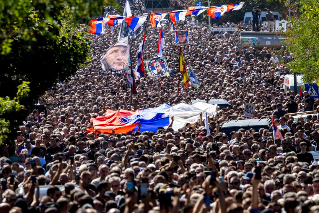 People gathered for the funeral procession wave a flag showing the former Bosnian Serb army commander Ratko Mladic on the day of the funeral for Ratko Mladic at St. Luka Church in Belgrade, Serbia, on Sept. 7, 2026. On Aug. 27, Serbian state media announced that the Bosnian Serb general Ratko Mladic, who was serving a life sentence in The Hague prison for war crimes during the 1992–1995 war in Bosnia, died while in a prison hospital. (Srdjan Stevanovic/Getty Images)