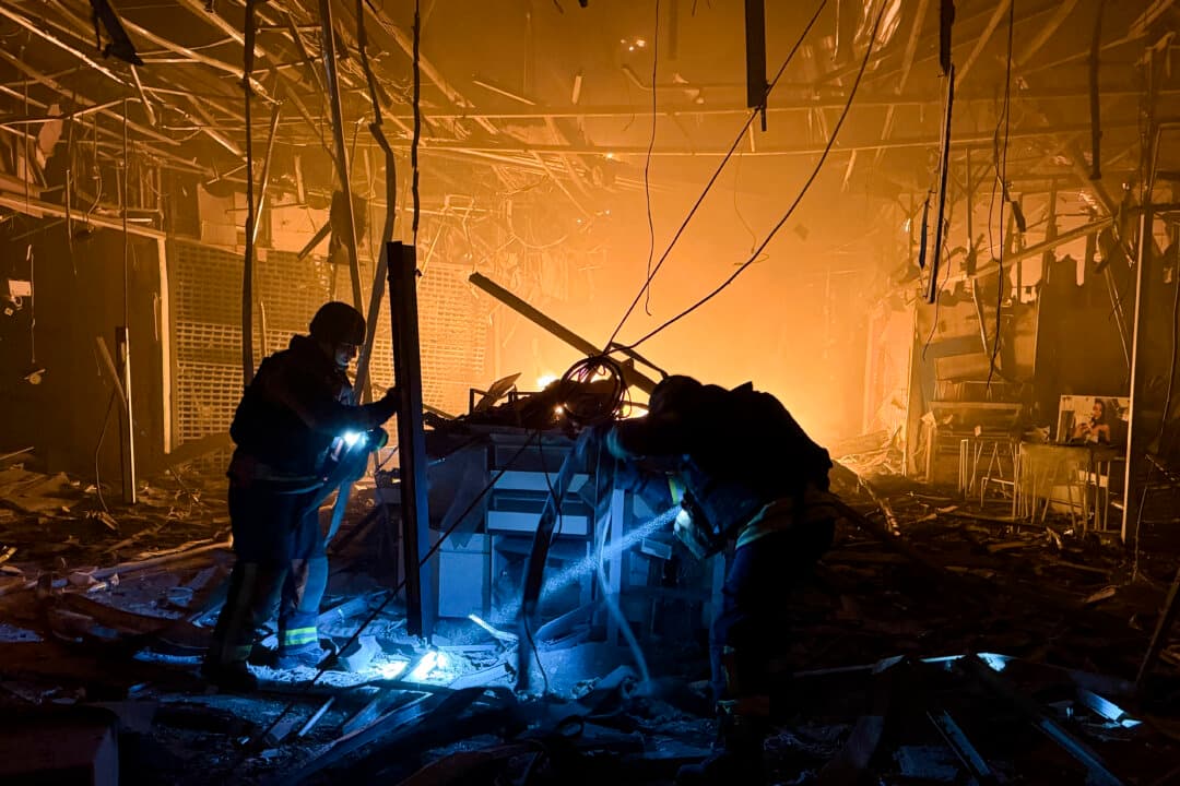 Ukrainian rescue personnel work to extinguish a fire in a damaged shopping mall following a Russian air attack in Zaporizhzhia, Ukraine, on Sept. 7, 2026. (Darya Nazarova/AFP via Getty Images)