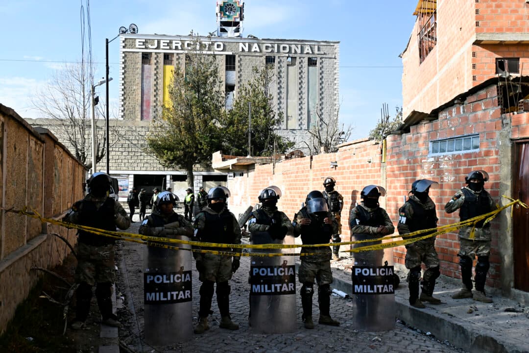 Military police officers stand guard on a street leading to an army barracks following an explosion on the eve, in Viacha, Bolivia, on Sept. 5, 2026. At least two people were killed, 81 were injured, and 14 people are still missing after a powerful explosion on Sept. 4, 2026, at a military facility storing pyrotechnic material in Bolivia. The cause of the blast remains under investigation. (Aizar Raldes/AFP via Getty Images)