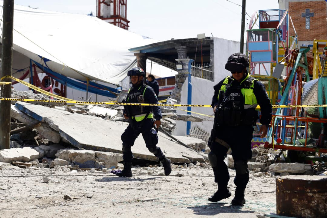 Mexican State Police officers inspect the site of a fireworks blast in Santa Maria Canchesda, Mexico state, Mexico, on Sept. 6, 2026. A fireworks explosion at a church while hundreds of people were celebrating a patron saint's festival in Mexico killed at least 10 people and left more than 60 injured, authorities reported on Sept. 6, 2026. (Ramses Mercado/AFP via Getty Images)