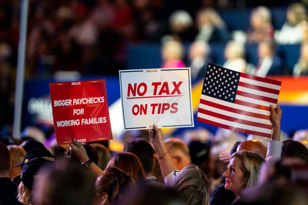 Attendees hold “No Tax on Tips” signs during the second day of the 2026 Republican National Committee Midterm Convention in Dallas on Sept. 10, 2026. (Madalina Kilroy/The Epoch Times)