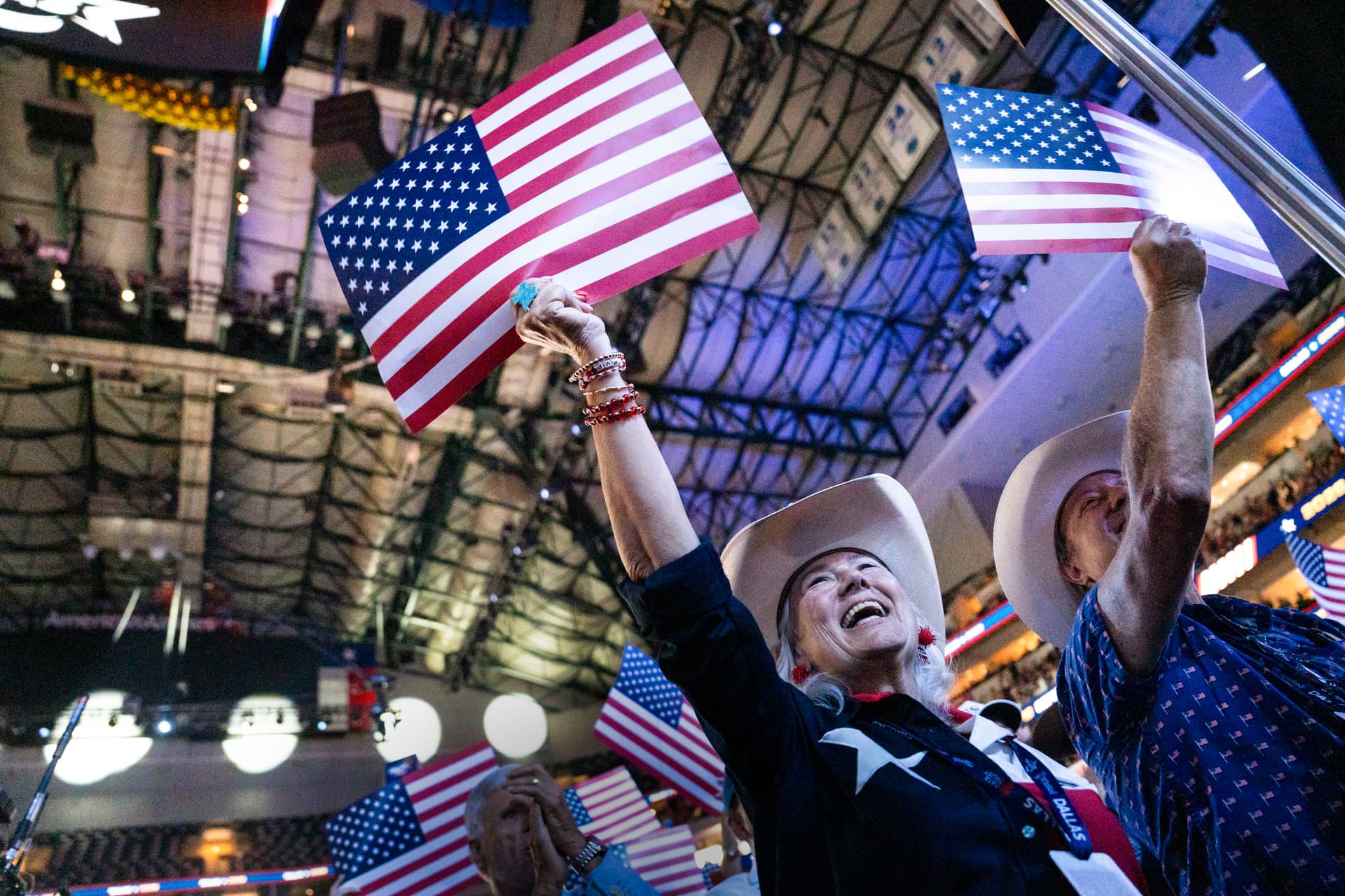 People hold the American flag as the 2026 Republican National Committee Midterm Convention ends in Dallas on Sept. 10, 2026. (Madalina Kilroy/The Epoch Times)