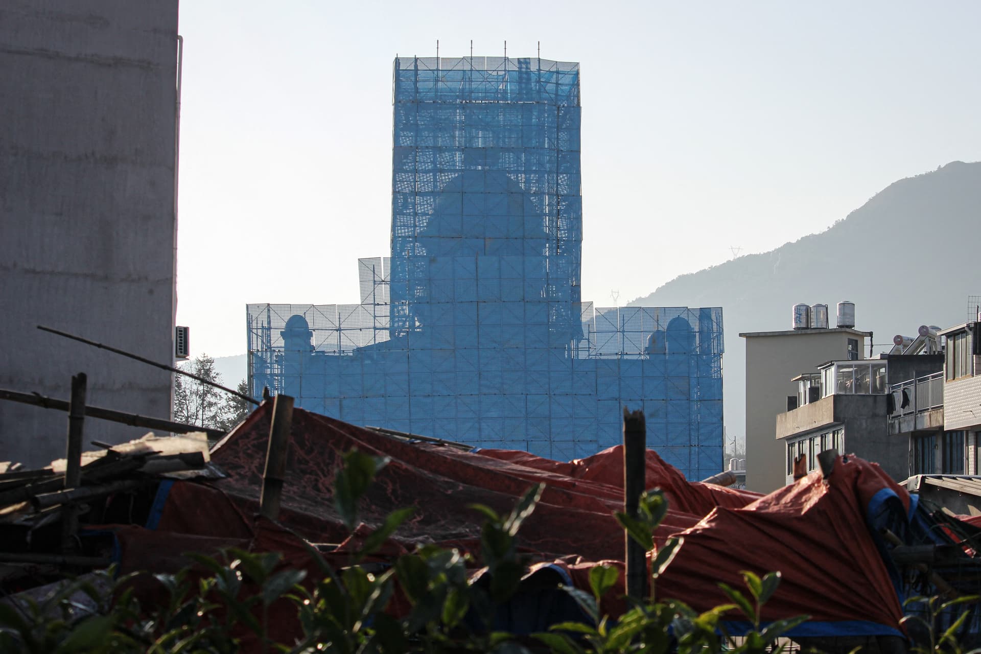 The Yayang church is covered in scaffolding in Yayang township, Wenzhou city, Zhejiang Province, China, on Jan. 9, 2026. Residents and rights groups say there have been multiple arrests as a national clampdown on unofficial Christian organizations grows. (Rebecca Bailey/AFP via Getty Images)