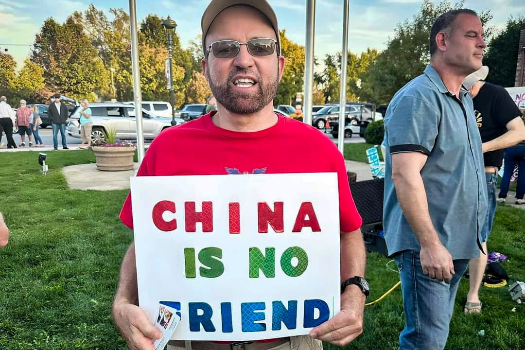 (Top Left) Activists Jillian Rojas, Amanda Piker, and a fellow community member hold signs during a protest walk in Manteno, Ill., on Oct. 22, 2023. (Top Right) Activist Ann Gates protests outside the battery plant location in Manteno, Ill., on Sept. 8, 2023—the day Illinois Gov. JB Pritzker announced the project. (Bottom Left) Darrel Bruck, founder of a Kankakee County group that opposes the Gotion battery plant, holds a sign at a protest and news conference outside Manteno Village Hall in Manteno, Ill., on Oct. 2, 2023. (Bottom Right) Manteno residents hold signs voicing opposition to the Gotion battery plant, in this file photo. (Courtesy of Amanda Piker, Courtesy of Concerned Citizens of Manteno)