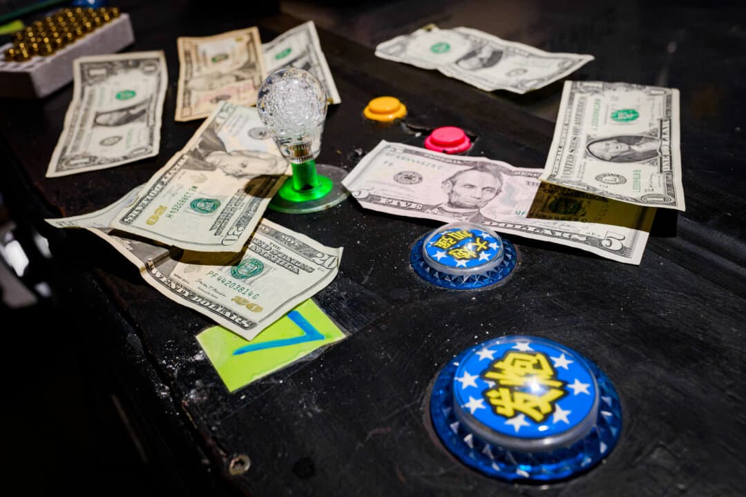 Cash and drugs litter a digital game console at an underground casino in Los Angeles County on Aug. 20, 2026. (Michael Ares for The Epoch Times)