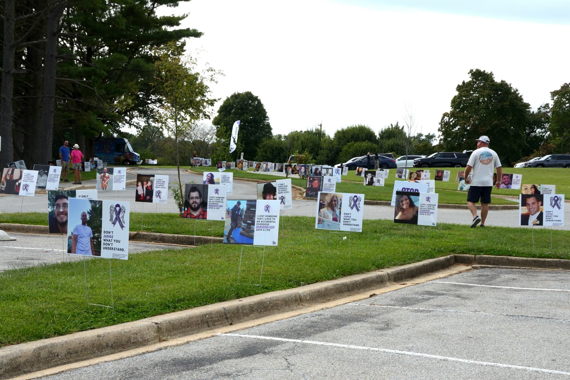 Memorial signs, bearing the portraits and stories of loved ones lost to the overdose epidemic, line the grounds of Delcastle Recreational Park during Overdose Awareness Day Delaware on Sept. 12, 2026. (Frank Liang/The Epoch Times)
