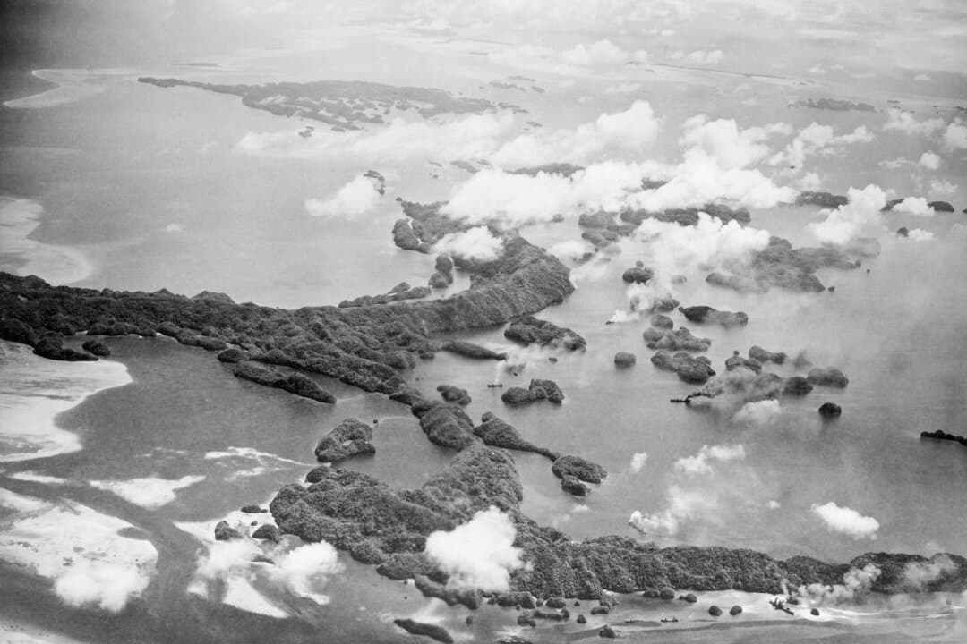 Columns of smoke arise from docks and buildings on Palau on June 29, 1944, as U.S. Navy bombers bombard a Japanese base there. Successive colonial powers—Spain, Germany, and Japan—ruled Palau before the archipelago came under U.S. administration as a United Nations trust territory in 1947. (AP Photo)