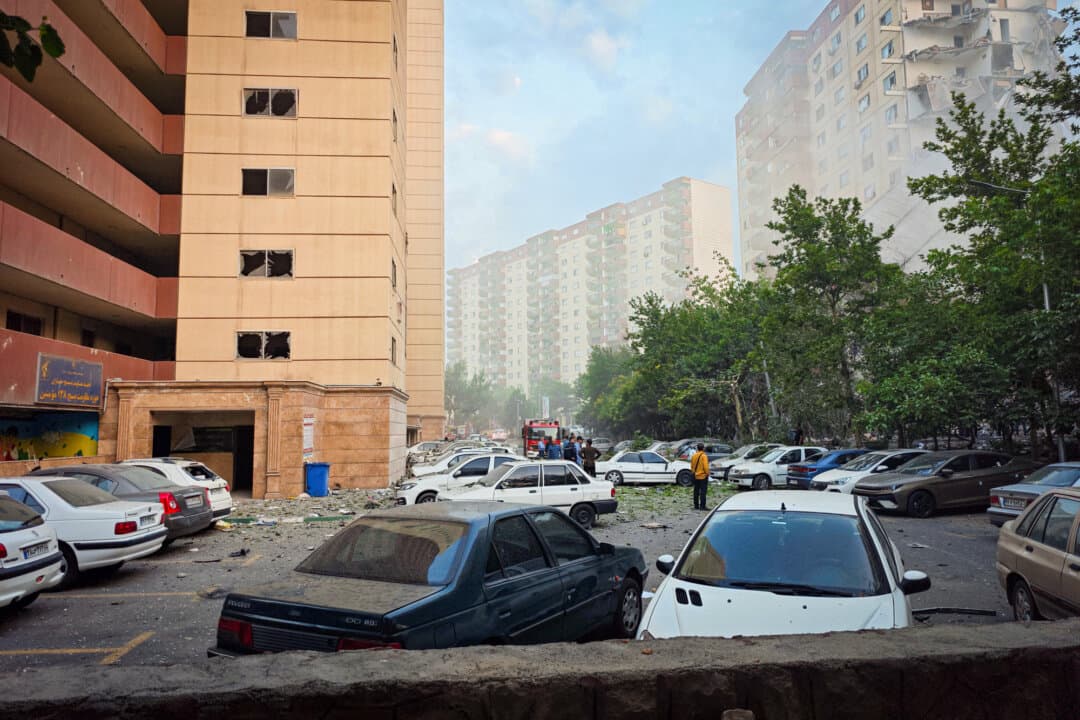 Residential buildings in Nobonyad Square show damage suffered in Israeli airstrikes in Tehran, Iran, on June 13, 2025. In March 2026, Israeli authorities brought charges against an Israeli Air Force reserve major on allegations he placed Polymarket predictions on the June 2025 Israeli operations against Iran. (Majid Saeedi/Getty Images)