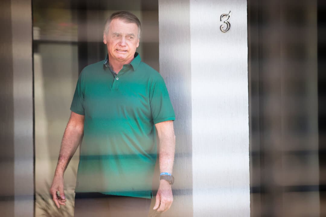 Former Brazilian President Jair Bolsonaro stands at the entrance of his home, where he is under house arrest in Brasília, Brazil, on Sept. 11, 2025. (Luis Nova/AP Photo)
