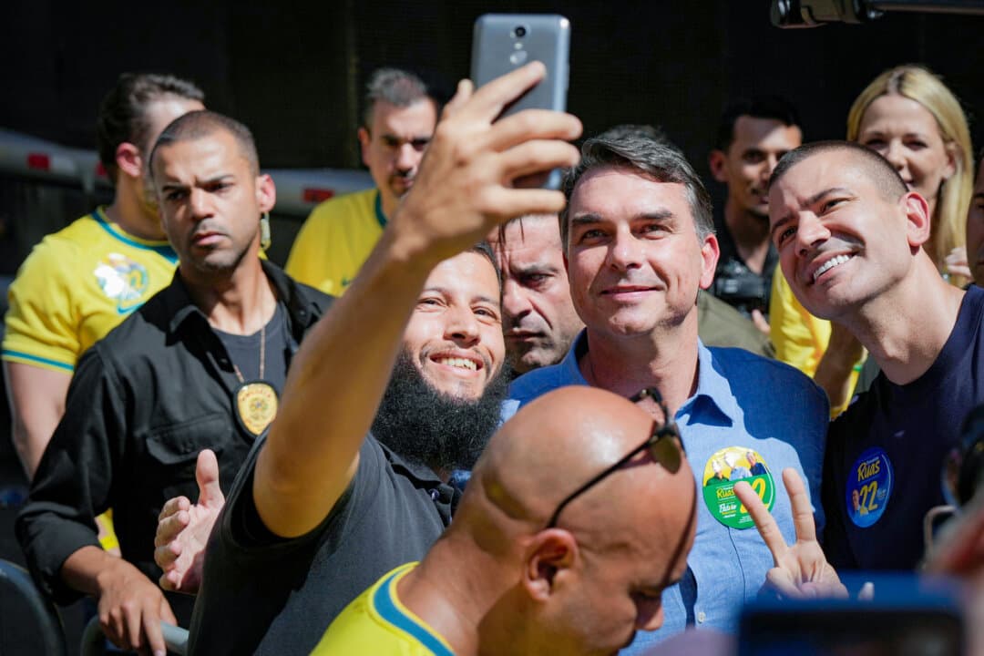 Opposition presidential candidate Flavio Bolsonaro (2nd R) poses for a photo with supporters after a campaign event in Rio de Janeiro on Aug. 21, 2026. (Silvia Izquierdo/AP Photo)