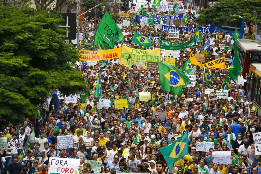 Demonstrators hold banners that translate as “Institutional crisis in Brazil” and “Dilma knew” as they take part in a protest demanding the impeachment of President Dilma Rousseff, in São Paulo on Nov. 15, 2014. Brazilian presidential candidate Renan Santos was a leading force in anti-Rousseff demonstrations. (Miguel Schincariol/AFP via Getty Images)