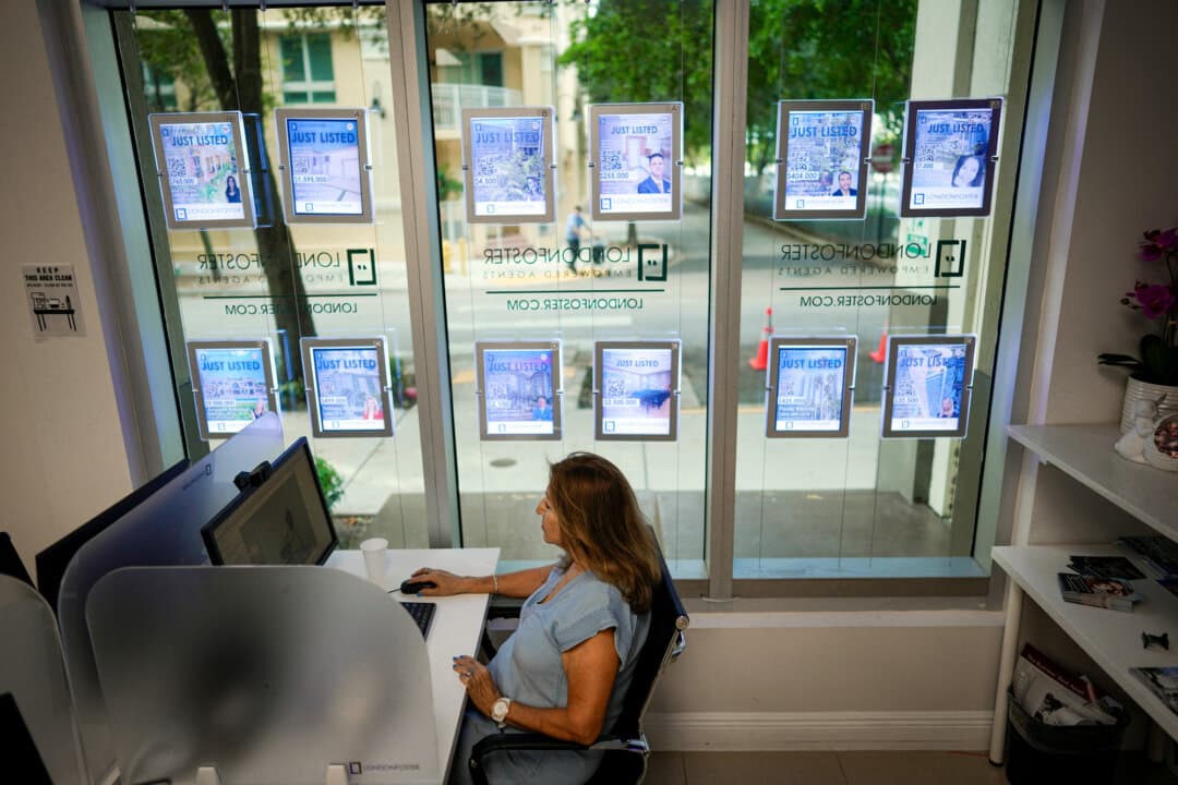 A real estate agent works in front of digital listings as she waits for clients in Kendall, Fla., on Oct. 19, 2023. (Rebecca Blackwell/AP Photo)