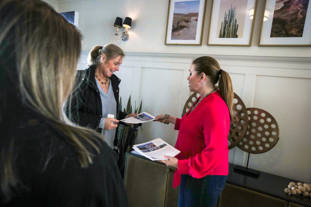 A real estate agent passes out flyers during a broker open house in San Francisco on April 16, 2019. (Justin Sullivan/Getty Images)