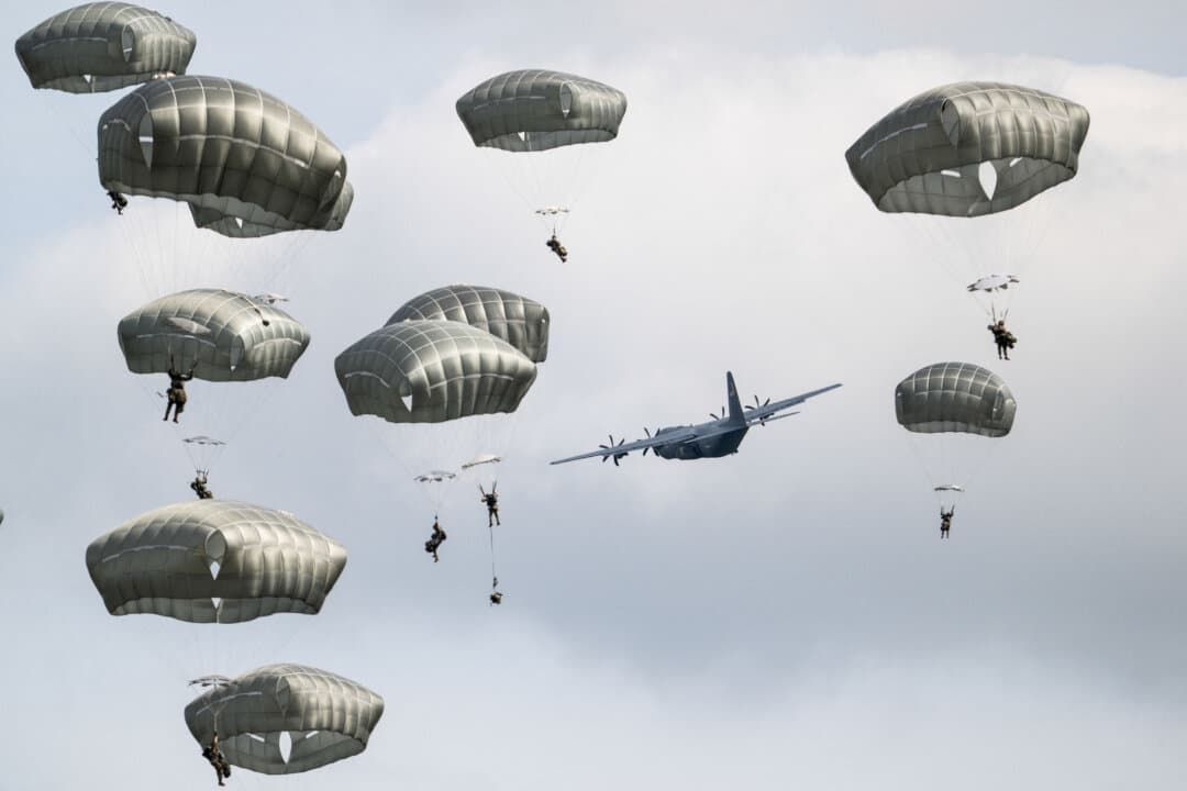 U.S. Army paratroopers with the 11th Airborne Division jump from a U.S. Air Force C-130J Super Hercules during Operation Orient Shield 26 at the Kita-Dalen Training Area in Eniwa, Hokkaido, Japan, on Sept. 15, 2026. (Andrew Caballero-Reynolds/AFP via Getty Images)
