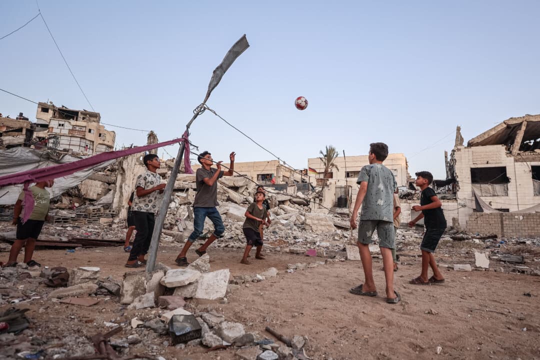 Palestinian children play volleyball on a makeshift court made of rubble in Gaza City on Sept. 15, 2026. (Omar Al-Qattaa/AFP via Getty Images)