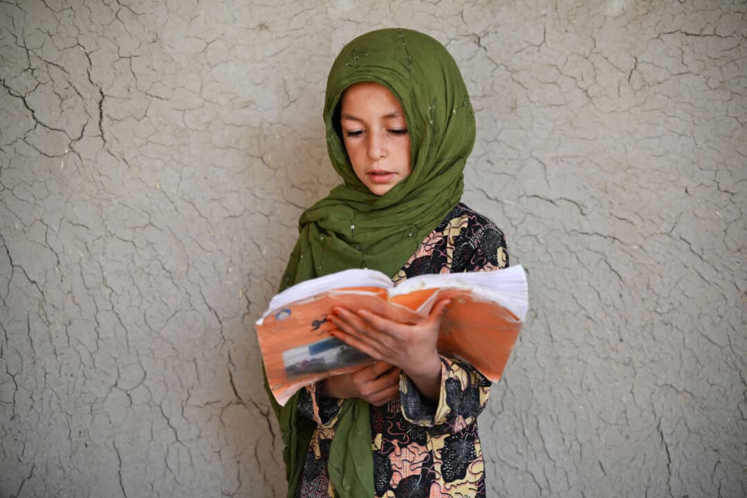 An Afghan girl reads a book at a school in Zhari district, Kandahar province, Afghanistan, on Sept. 16, 2026. (Sanaullah Seiam/AFP via Getty Images)