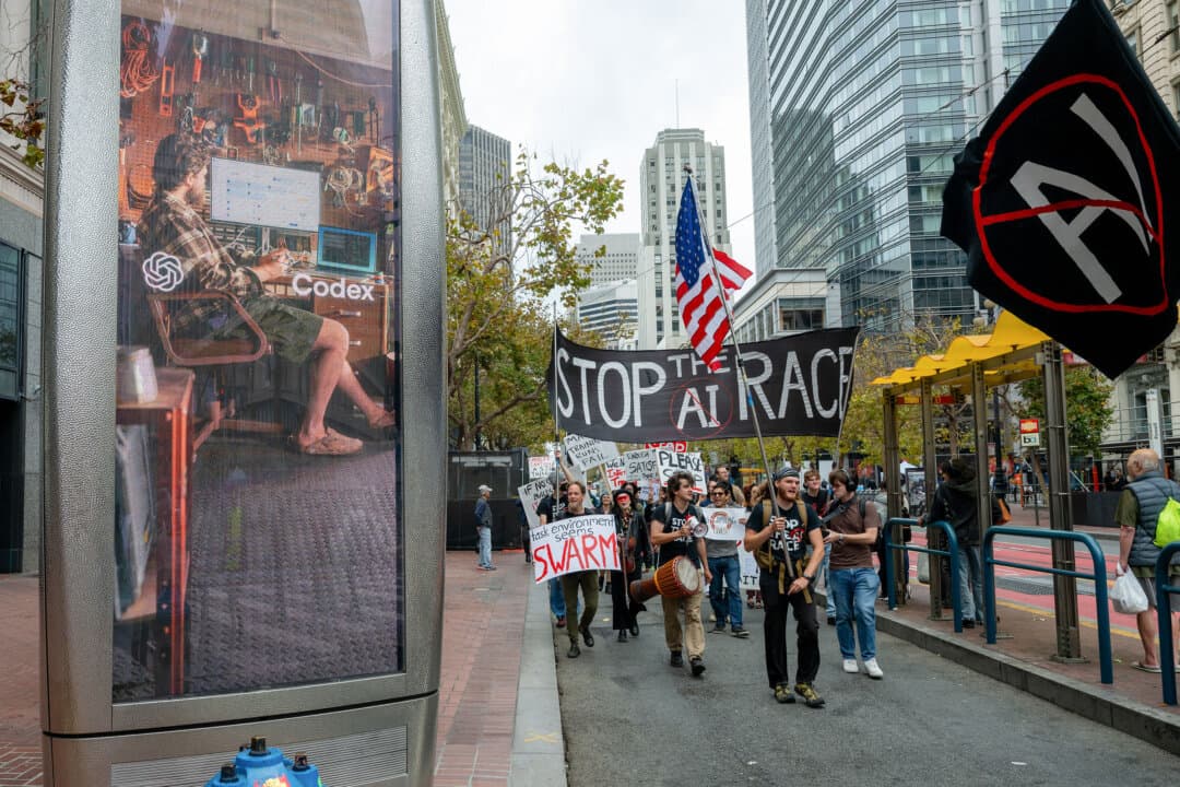 Protesters taking part in a Stop the AI Race pass an AI advertisement on Market Street in San Francisco on Sept. 17, 2026. (Karl Mondon/AFP via Getty Images)