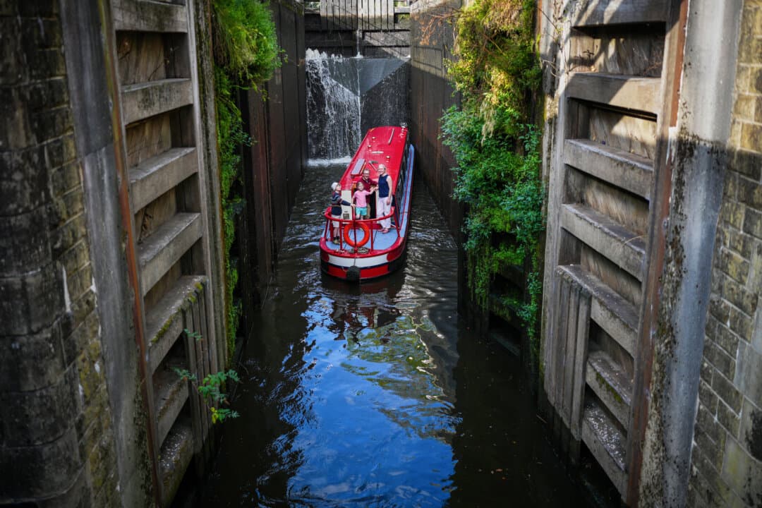 A narrow boat passes through Tuel Lane Lock in Sowerby Bridge, England, on Sept. 14, 2026. The lock raises and lowers boats nearly six meters and is the deepest lock in the UK. (Christopher Furlong/Getty Images)