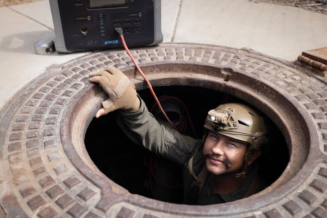 U.S. Border Patrol agent Michael Sablan prepares to crawl through a cartel tunnel that once led to a warehouse outside San Diego on Sept. 17, 2026. (John Fredricks/The Epoch Times)