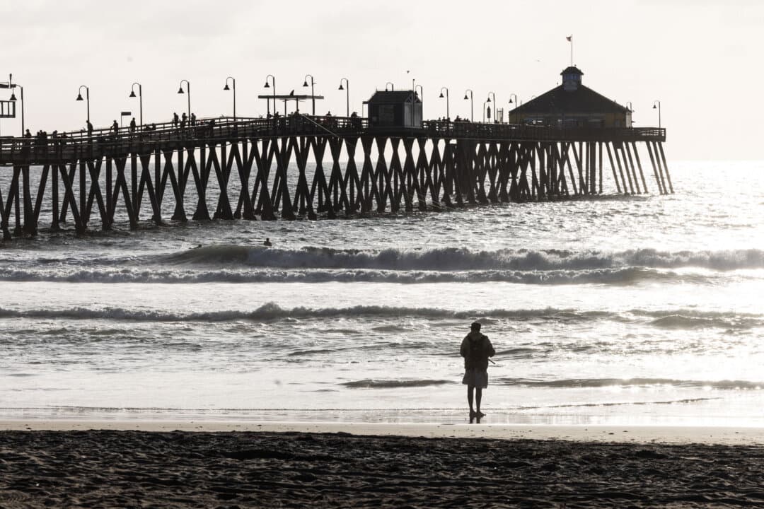 People walk along the sand at Imperial Beach, Calif., on Sept. 16, 2026. (John Fredricks/The Epoch Times)