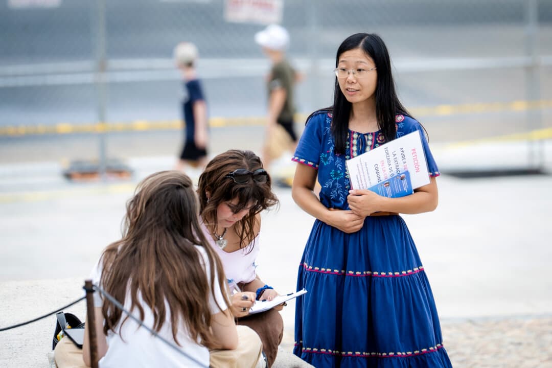 Falun Gong practitioner Alisa Zhou passes out flyers raising awareness about the Chinese Communist Party's ongoing persecution against Falun Gong, at the Lincoln Memorial in Washington on Sept. 19, 2026. Zhou's mother, an adherent of Falun Gong, has been detained in China since April. (Madalina Kilroy/The Epoch Times)