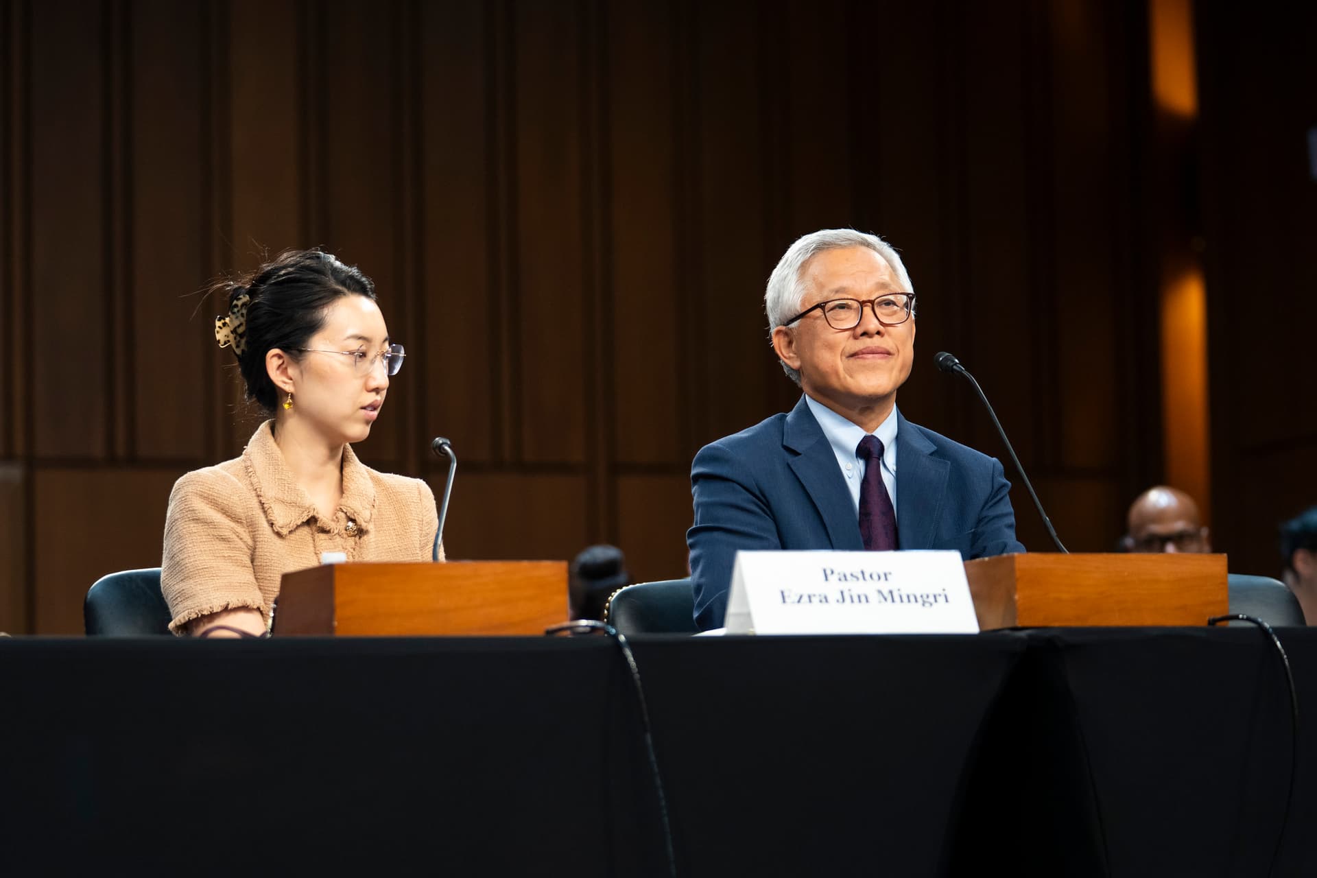 Former political prisoner Ezra Jin Mingri, pastor of the Zion Church of Beijing, and his daughter, Grace Jin Drexel, speak during a hearing on Capitol Hill in Washington on Sept. 22, 2026. (Madalina Kilroy/The Epoch Times)
