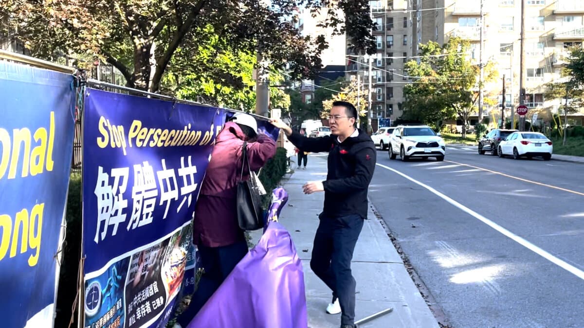 A man attacks a Falun Gong practitioner on a public sidewalk outside the Chinese Consulate in Toronto on Sept. 22, 2026. (Screenshot/Handout)