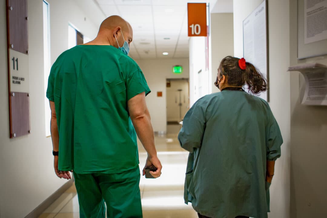 Hospital staff walk down a hall at UCI Medical Center in Orange, Calif., on Dec. 16, 2020. (John Fredricks/The Epoch Times)