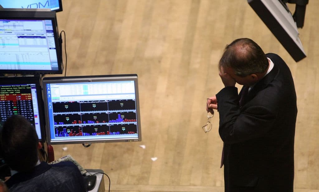 A trader wipes his brow while working on the floor of the New York Stock Exchange on Aug. 10, 2007. (Mario Tama/Getty Images)