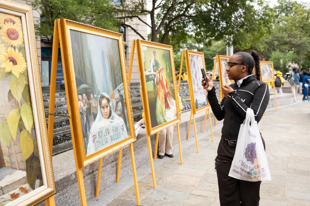 A Zhen Shan Ren art exhibit is displayed as Falun Gong practitioners hold a rally to demand an end to the Chinese Communist Party's persecution of the spiritual practice, during Chinese leader Xi Jinping's state visit to Washington on Sept. 24, 2026. (Samira Bouaou/The Epoch Times)