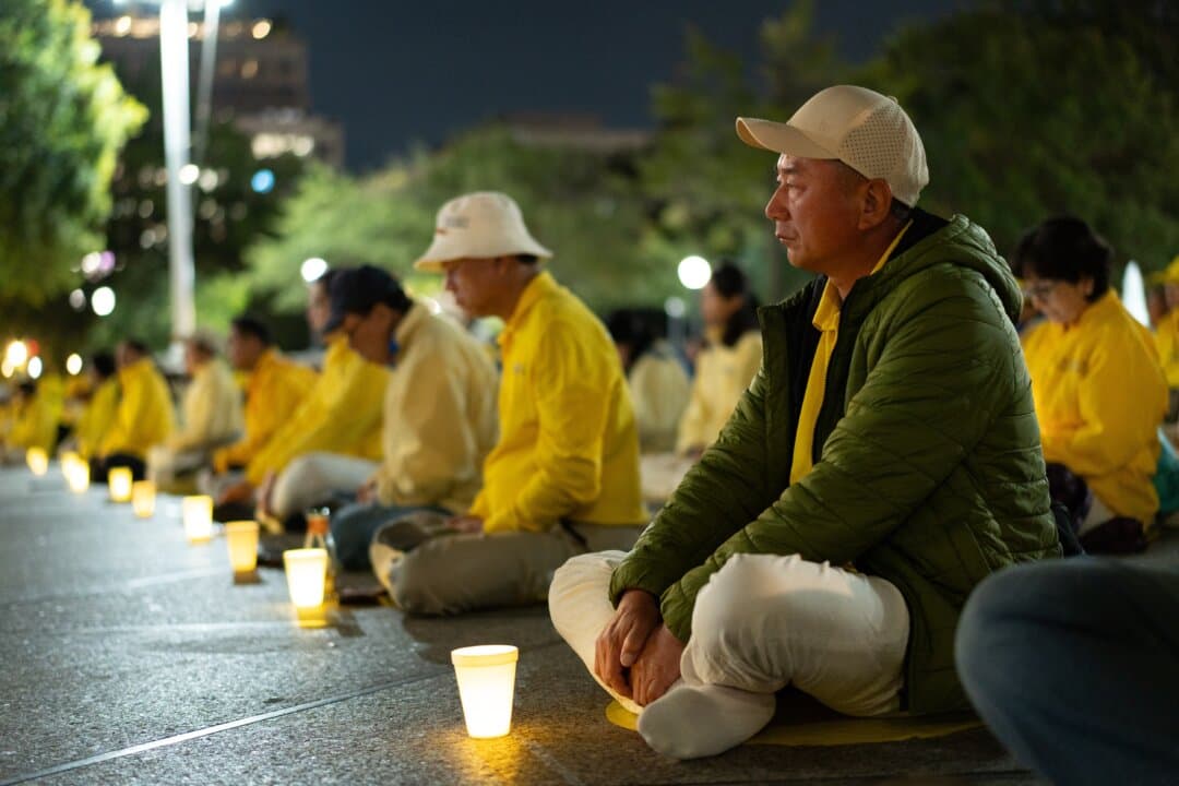 Falun Gong practitioners hold a candlelight vigil to call for an end to the Chinese Communist Party's persecution of the spiritual practice, during Chinese leader Xi Jinping's state visit to Washington on Sept. 24, 2026. (Samira Bouaou/The Epoch Times)