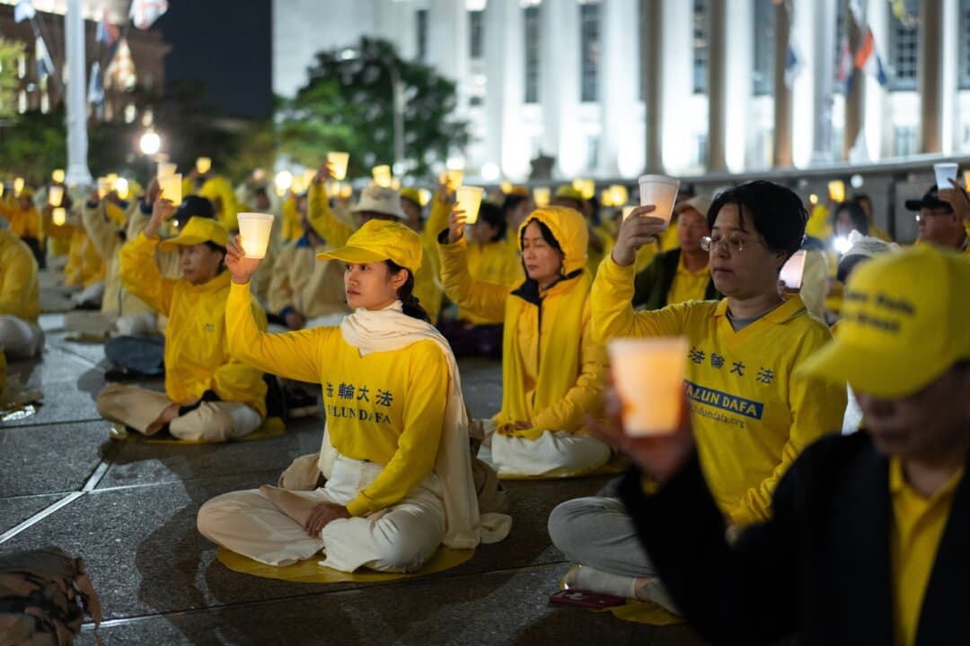 Falun Gong practitioners hold a candlelight vigil to call for an end to the Chinese Communist Party's persecution of the spiritual practice, during Chinese leader Xi Jinping's state visit to Washington on Sept. 24, 2026. (Samira Bouaou/The Epoch Times)