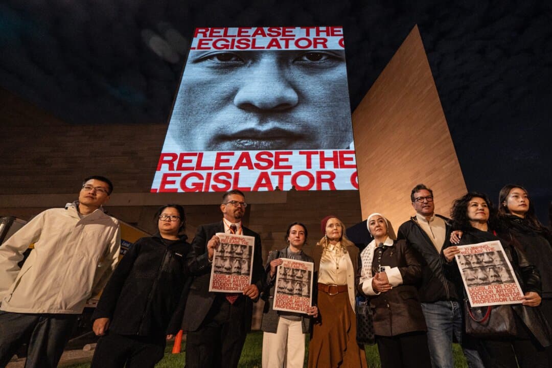 The faces and names of some political prisoners held in China are projected on the building of the National Gallery of Art as Chinese leader Xi Jinping visits Washington on Sept. 23, 2026. (Samira Bouaou/The Epoch Times)