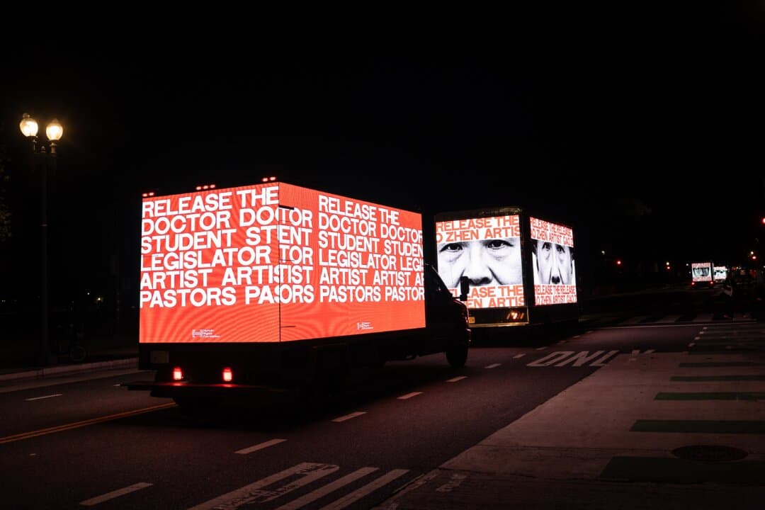 The faces and occupations of some political prisoners held in China are displayed on trucks as Chinese leader Xi Jinping participates in a state visit to Washington on Sept. 23, 2026. (Samira Bouaou/The Epoch Times)