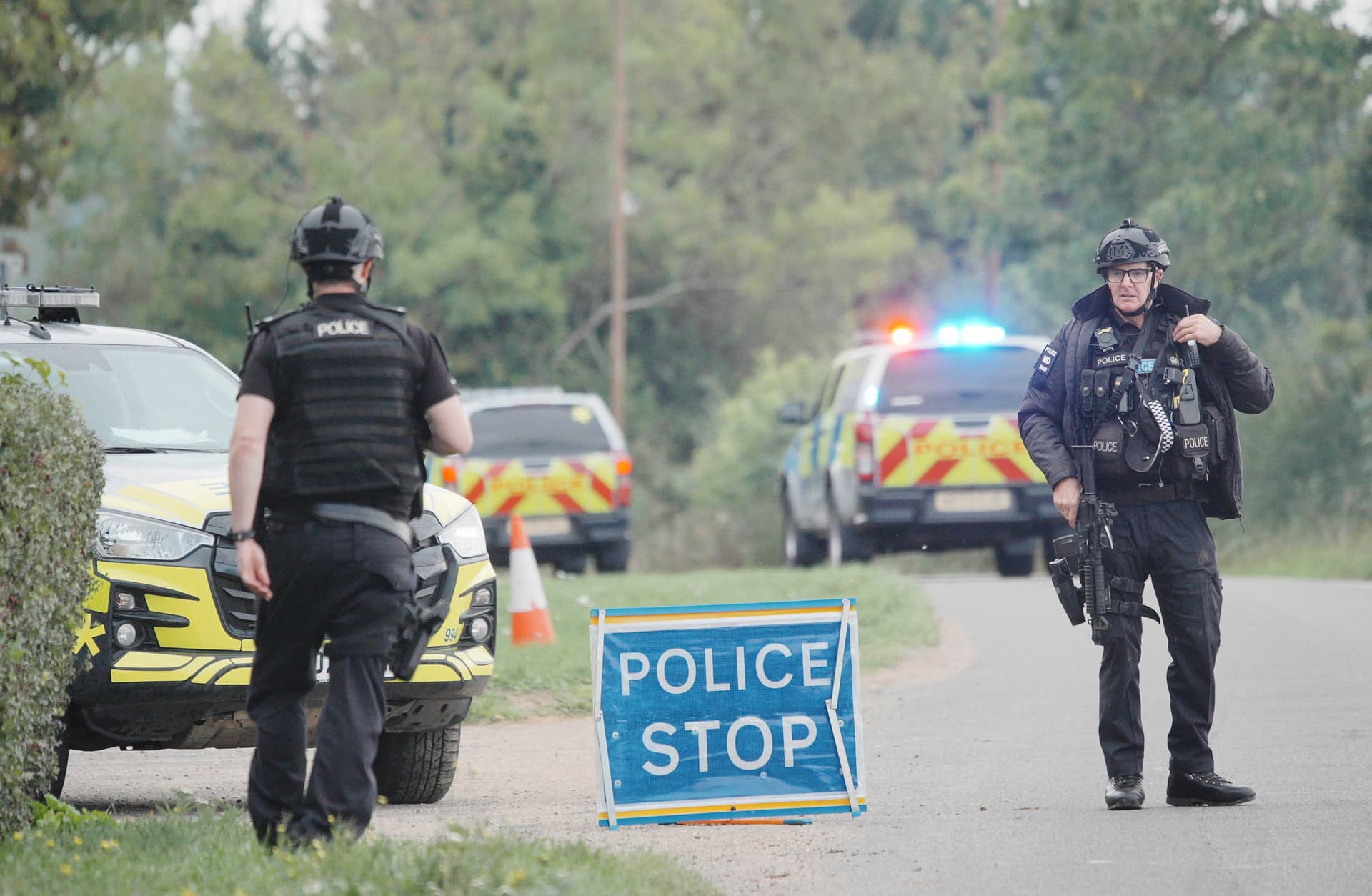 Police stand at a roadblock on the road to RAF Fairford after an incident in Whelford, England, on Sept. 27, 2026. (Ben Birchall/PA via AP)