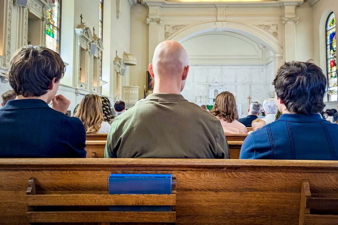 Young men pray during a Catholic Mass in Camarillo, Calif., on Sept. 27, 2026. Gen Z males are "increasingly identifying religion as important in their lives," says religion scholar Kelsey Hanson Woodruff. (Monica Seeley/The Epoch Times)
