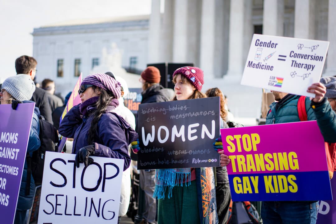 People protest as the Supreme Court hears a case over gender-related medical procedures for minors in Washington on Dec. 4, 2024. The Supreme Court will consider a case in December over whether parents can sue to prevent a state from administering gender-related medical procedures on their children without parental consent. (Madalina Vasiliu/The Epoch Times)
