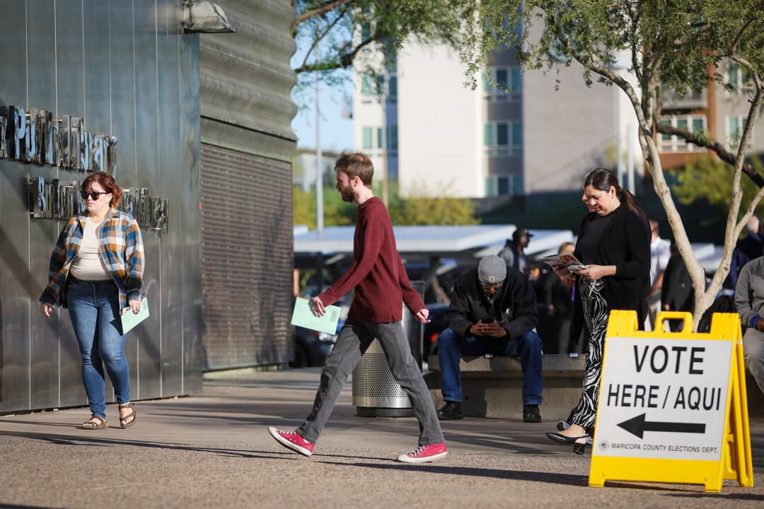 Voters arrive at a polling location at the Burton Barr Central Library in Phoenix on Nov. 5, 2024. On Dec. 8, the Supreme Court will consider whether Arizona can require voters to provide proof of citizenship and remove noncitizens from voter rolls before an election. (Christian Petersen/Getty Images)