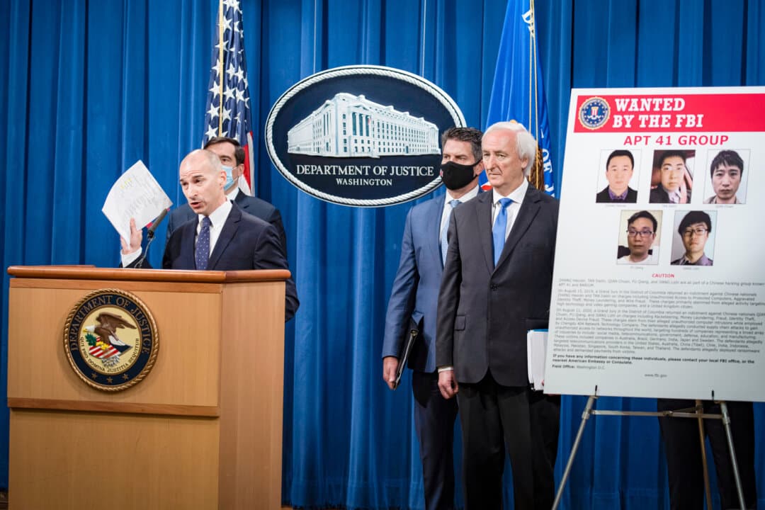 Then-acting U.S. Attorney for the District of Columbia Michael R. Sherwin announces the prosecution of Chinese citizens for hacks targeting more than 100 companies and institutions, at the Department of Justice in Washington on Sept. 16, 2020. The hacks infiltrated social media and game companies, universities, and telecommunications providers in the United States and abroad. (Tasos Katopodis/Pool via AP)