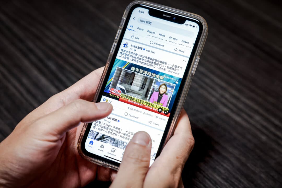 A user looks at news content on Facebook, in Taipei on Dec. 22, 2023, in this photo illustration. In the run up to Taiwan's January 2024 election, China inundated the island's voters with a wave of online misinformation, from deepfakes to TikTok videos. (I-Hwa Cheng/AFP via Getty Images)