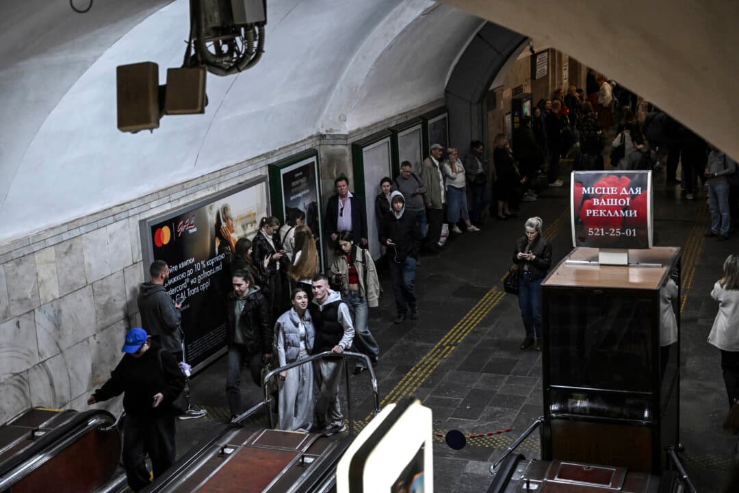 Passengers wait in a metro station during an air raid alert in Kyiv, Ukraine, on Oct. 7, 2026, after metro trains stopped crossing the Dnipro River amid the Russian invasion of Ukraine. (Sergei Supinsky/AFP via Getty Images)