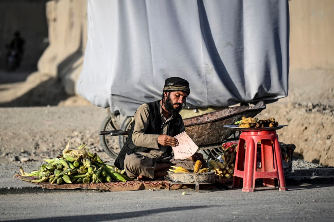An Afghan man sells corn along a road in the eighth district of Afghanistan's Kandahar province on Oct. 7, 2026. (Sanaullah Seiam/AFP via Getty Images)